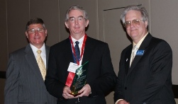 Dr. Dennis G. Hall (center) accepts ICCTA's 2009 Distinguished Alumnus Award from Illinois Community College Board chair Guy Alongi (left) and ICCTA president Jeff May.