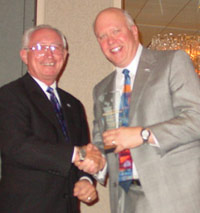 Dr. Gary W. Davis (right) accepts ICCTA's inaugural Ethical Leadership Award from longtime Elgin Community College trustee John Duffy
