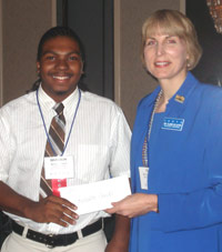 Brandon Smith accepts ICCTA's 2007 Gigi Campbell Student Trustee Excellence Award scholarship from ICCTA president Clare Ollayos.