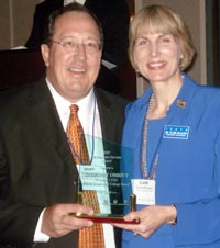 Geoffrey Obrzut accepts ICCTA's 2007 Meritorious Service Award from ICCTA president Clare Ollayos.
