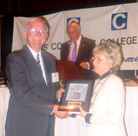 ICCTA Awards Committee chair Jim Beasley congratulates Outstanding Faculty Member winner Dr. Joan Ferrell of Southeastern Illinois College.