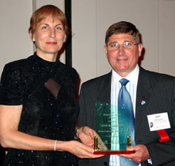 ICCB chair Guy Alongi accepts his Meritorious Service Award from ICCTA president Clare Ollayos.