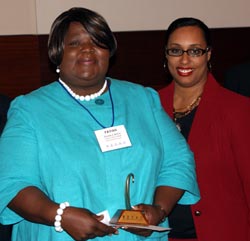 Prairie State College student Favian Apata (left)accepts her $500 Paul Simon Student Essay Contest scholarship from State Senator Toi Hutchinson.