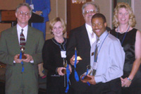 Joliet Junior College celebrates its College Bowl victory at ICCTA's June 9 awards dinner. From left: JJC College Bowl coach Bill Yarrow, JCC president Gena Proulx, JJC trustee/ICCTA vice president Jeff May, College Bowl team member John Downey, amd JJC trustee Barb Delaney