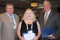 John A. Logan College student Amy Butler (center) accepts her $500 Paul Simon Student Essay Contest scholarship from JALC trustee Jake Rendleman (left) and ICCTA president Bill Kelley.