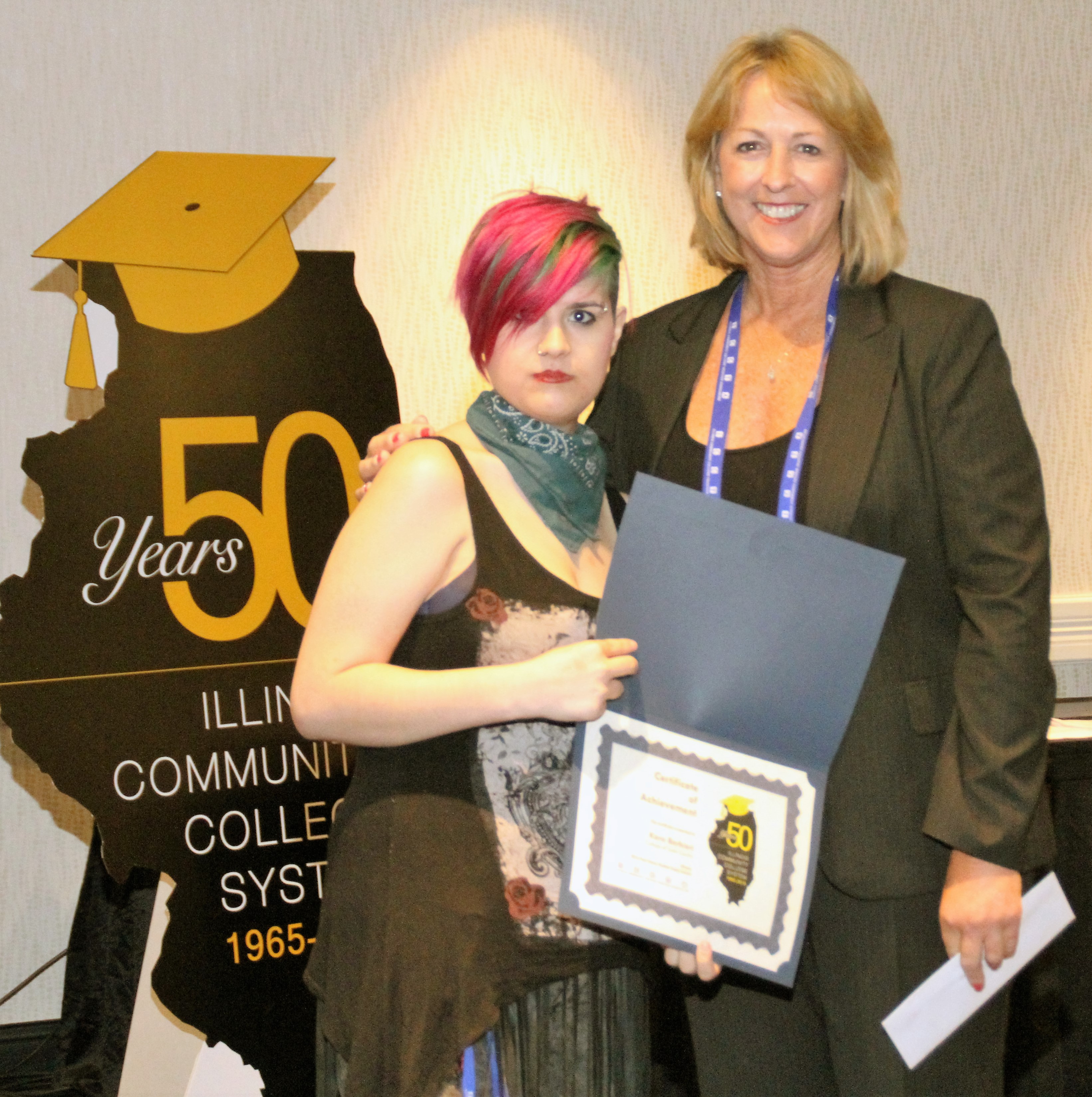 College of Lake County student Kara Barbieri accepts her $500 Paul Simon Student Essay Contest scholarshipfrom ICCTA vice president Linda Liddell.