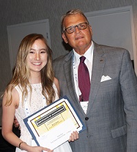 Southeastern Illinois College student Ruth Chae accepts her $500 Paul Simon Student Essay Contest scholarshipfrom Illinois Community College System Foundation president Dr. Joe Kanosky.