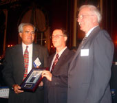 Kaskaskia College trustee Jim Beasley (right) presents representatives of Forsheda Engineered Seals with ICCTA's Business/Industry Partnership Award.