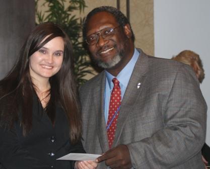 Kiersten Kasey accepts ICCTA's $500 Gigi Campbell Student Trustee Excellence Award scholarship from ICCTA vice president Reggie Coleman.