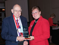 John McDowell accepts ICCTA's 2009 Lifelong Learning Award from ICCTA president Barbara Oilschlager.