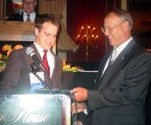 ICCTA past president Linden Warfel (right) congratulates Gigi Campbell Student Trustee Excellence Award winner David Moore of Parkland College.