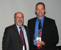 Joseph Fatheree (right) accepts ICCTA's 2012 Outstanding Part-Time Faculty Member Award from Association of Community College Trustees president/CEO Noah Brown.