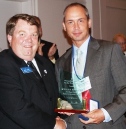 Ronald B. Kowalczyk (right) accepts ICCTA's 2010 Outstanding Part-Time Faculty Member Award from ICCTA vice president Harby.